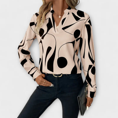 Blouse élégante à manches longues avec décolleté en V et motif géométrique