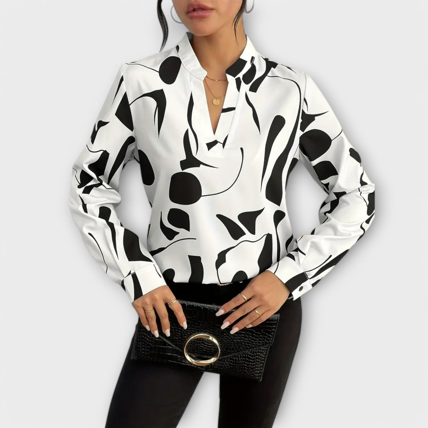 Blouse élégante à manches longues avec décolleté en V et motif géométrique